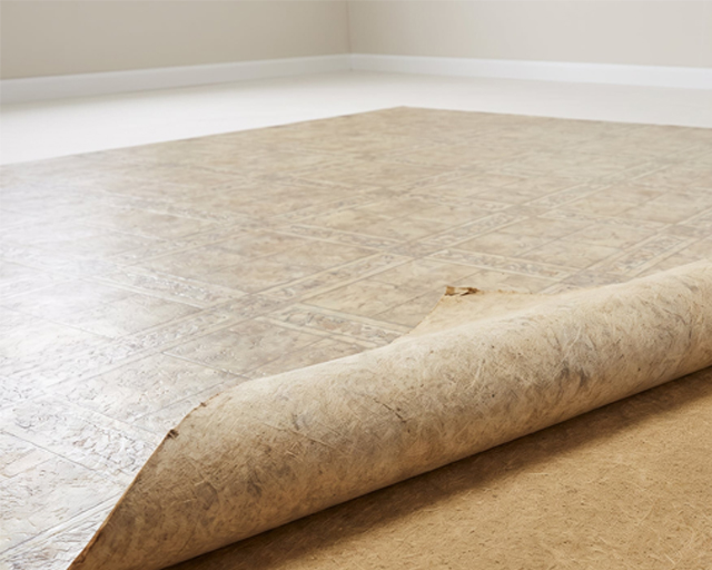 An image shows peeling linoleum during the flooring removal process.