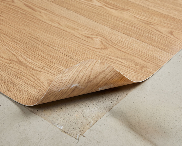 An image shows vinyl flooring removal. Always test for asbestos before removing older vinyl flooring.