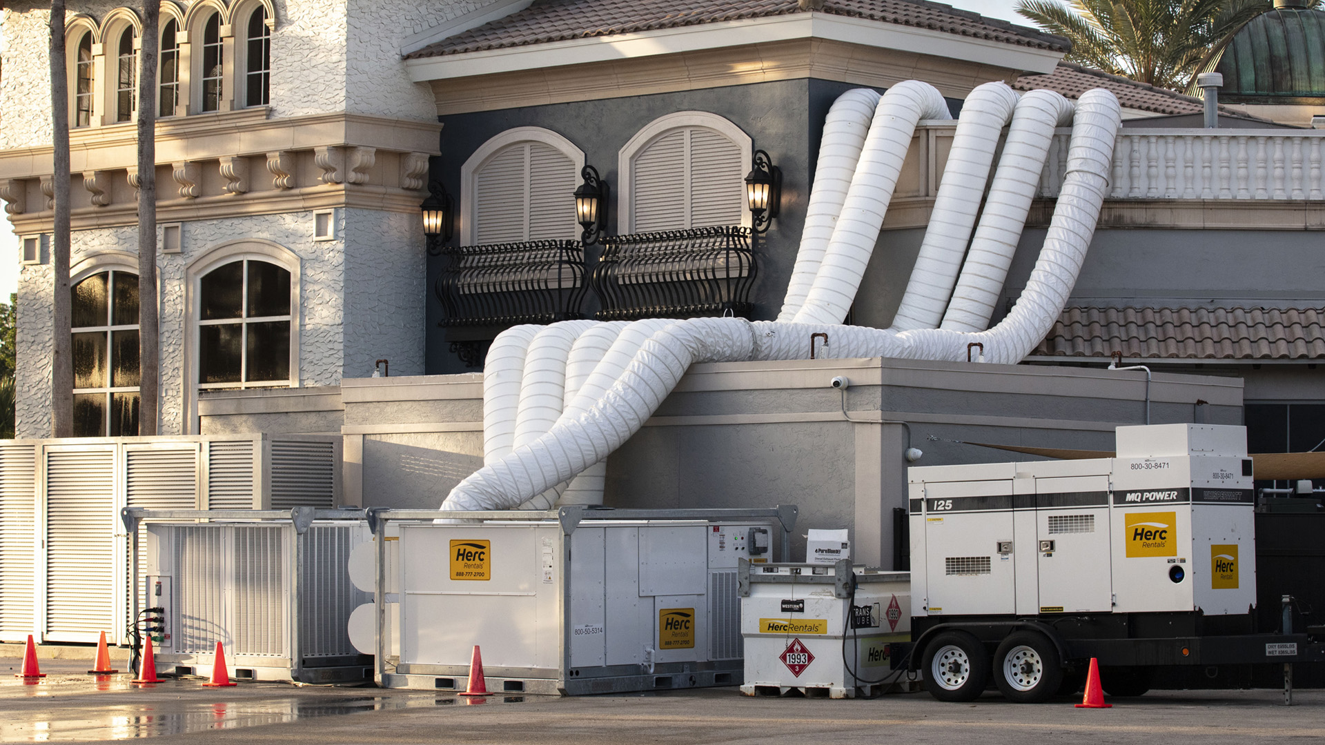 A temporary air conditioner is pictured outside of a building.