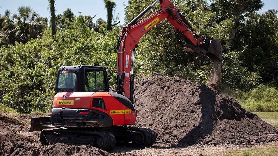 Preparing ground for concrete entails using earthmoving equipment.