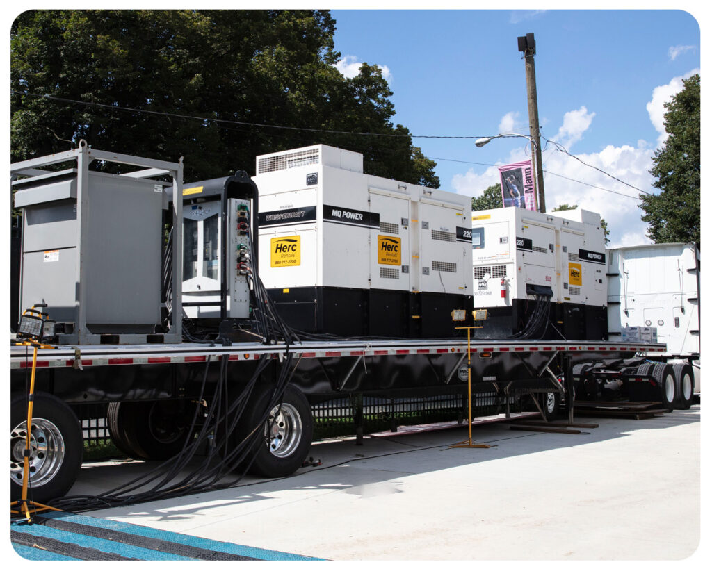 Skid-mounted generators are pictured on a trailer bed. 