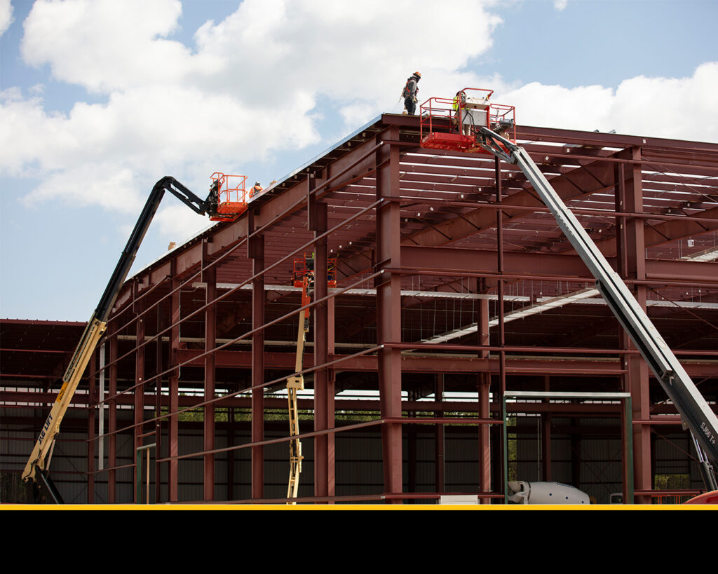 Pictured are a few boom lifts and employees wearing proper PPE during data center construction. 