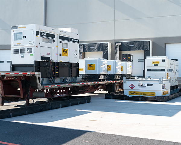 Power generators are in use on an industrial construction jobsite. 