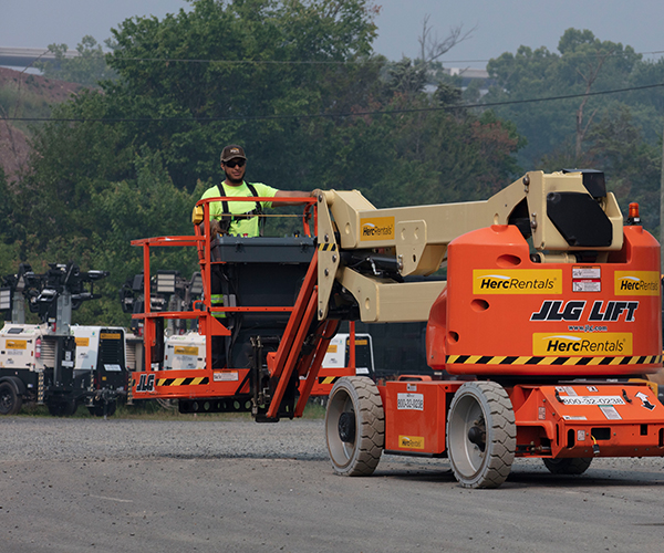 A worker demonstrates good aerial lift safety practices by wearing fall protection. 